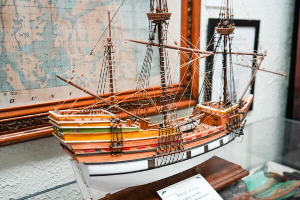 a model ship with a map in the background