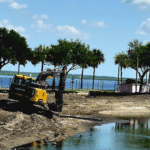 Construction trucks make progress on Lake Carola Project which began in March 2026.